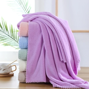 Set of multi-color thick coral fleece bath towels with soft microfiber texture and wavy edges