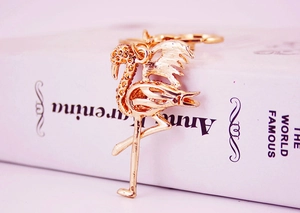 Close-up of a golden crystal-encrusted flamingo keychain with a detailed metal finish