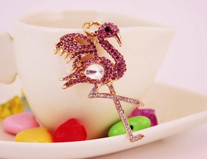 Detail of flamingo keychain with purple rhinestones and metal ring for bags and keys