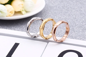 Detailed view of bamboo-shaped titanium steel rings in gold, silver, and rose gold finishes