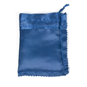 Close-up of blue satin drawstring pouch featuring decorative serrated edge stitching