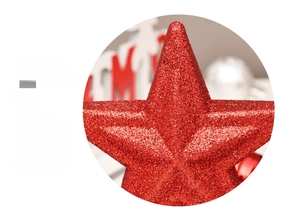 Close-up of a 3D red glitter star Christmas tree topper with textured sparkling surface