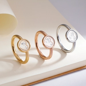 Three minimalist heart rings in gold, rose gold and silver finishes with floating stones