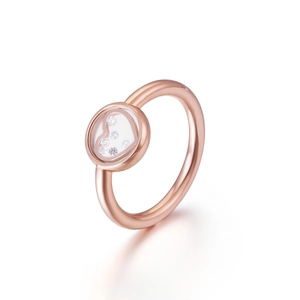 Minimalist rose gold heart ring with floating diamonds under glass in white background