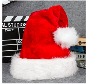 Close-up of fluffy red plush Santa hat with thick white faux fur trim and soft pom-pom