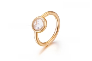 Detail of 18K gold plated heart ring featuring five floating zircons inside the crystal
