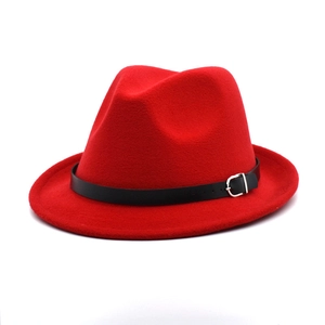 Detail of red wool fedora hat featuring a black leather band and silver buckle accent