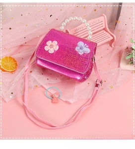 Detail of rose red sequin girls purse with pearl handle and 3D floral accents