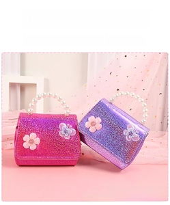 Close-up of glitter girls purse with 3D floral accents and pearl beaded handle
