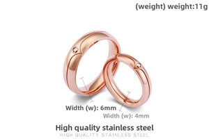 Macro detail of rose gold titanium steel couple rings with zircon inlays on white backdrop