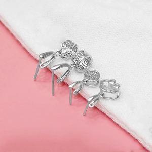 Detailed view of four assorted S925 sterling silver pinch bails for DIY jewelry making