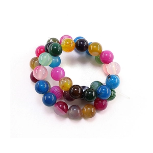 Polished natural agate beads in multiple colors for DIY jewelry making on white background
