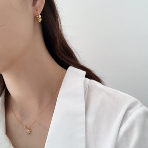 Detail of 925 sterling silver star pendant necklace and ball earrings on a model