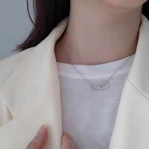 Detailed close-up of 925 sterling silver interlocking rectangle necklace with zirconia