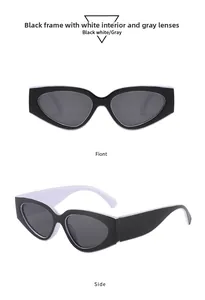 Detail view of cat eye sunglasses with black outer and white inner frames and gray lenses