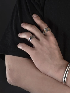 Adjustable stainless steel smiley face ring and floral band set on model's hand