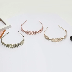 Three elegant metal leaf headbands in silver, rose gold, and gold finishes for women