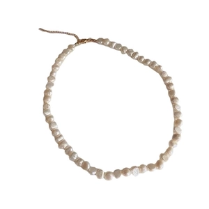 Baroque freshwater pearl necklace with adjustable gold clasp on a clean white background