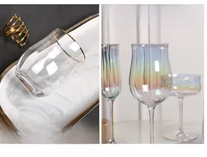 Detail showing iridescent wine glasses with elegant plating-golden rim on white marble tray