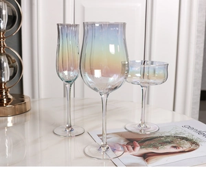 Detailed view of iridescent tulip glass set with vertical ribbed texture on marble surface