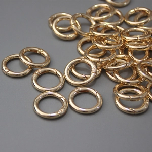 Close-up of golden spring O-ring buckles with polished finish for DIY bag accessories