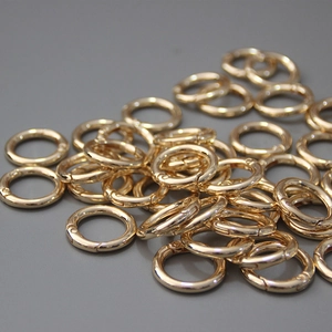 Macro shot of polished gold O-ring spring clasps for DIY bag accessories and jewelry