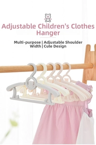 Adjustable plastic children hangers with bear motif hanging pink dress on wooden rod