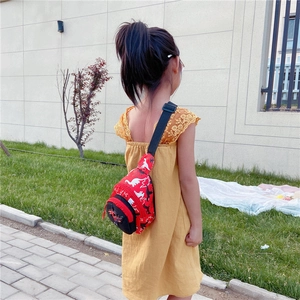 Detailed view of the red dinosaur printed kids crossbody bag with 3D soft dino accent