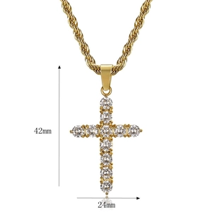 Detailed close-up of a 42mm gold-plated hip hop cross pendant with clear cubic zirconia