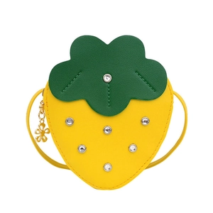 Cute yellow strawberry-shaped crossbody bag for girls with green leaves and a floral charm