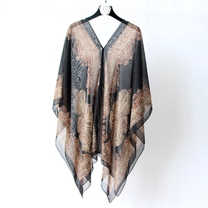 Detailed view of a lightweight translucent chiffon beach shawl featuring elegant paisley print
