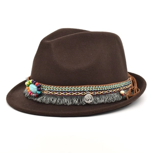 Detail of wool fedora hat with bohemian bead strap, turquoise stone and silver coin