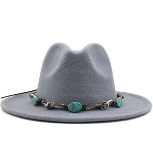 Detail of gray wool fedora featuring a turquoise beaded and braided leather ethnic band