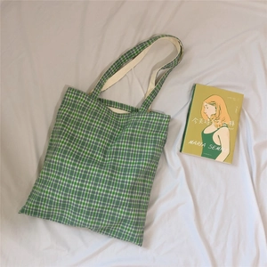 Green and white checkered canvas tote bag with long handles for women in a flat lay view
