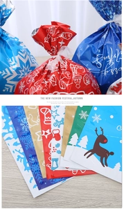 Detail of assorted Christmas drawstring gift bags with reindeer and snowflake patterns