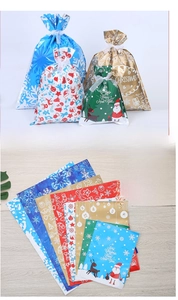 Macro view of assorted Christmas drawstring gift bags with snowflake and reindeer patterns
