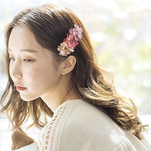 Elegant side view of a floral hair clip with pink and beige fabric flowers for women
