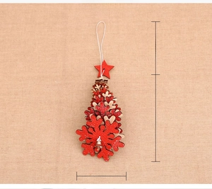 Detail of wooden Christmas tree ornament with glitter snowflakes and metal bell