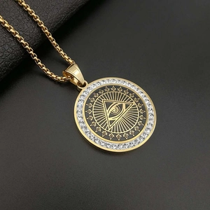 Gold plated All-Seeing Eye pendant necklace with sparkling rhinestones on black leather background
