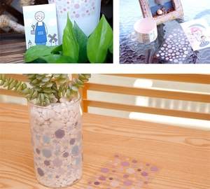 Detail of semi-transparent geometric washi stickers in purple and pink on a glass vase