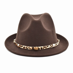 Detail of dark brown wool fedora hat featuring leopard print band and gold star rivet