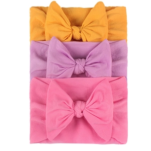 Set of 3 elastic nylon baby headbands with colorful bows in yellow, purple, and pink colors