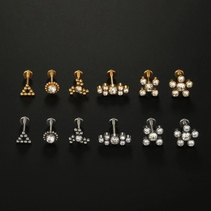 12-piece medical steel stud set with gold and silver finishes and sparkling crystals