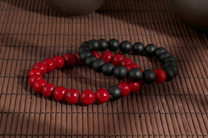 Detail of beaded couple bracelets with red marble turquoise and black matte stone beads