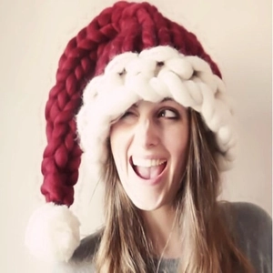 Handmade red and white chunky knit Christmas hat with long tail and oversized pompom detail