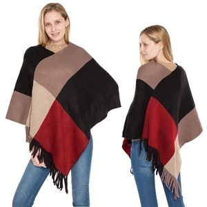 Detail of color-blocked knitted shawl with tassels in black, brown and red tones