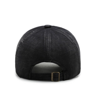 Rear view of washed black cotton baseball cap showing adjustable brass metal buckle closure