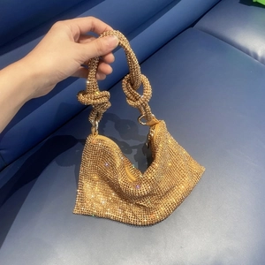 Detail of the sparkling gold rhinestone mesh handbag with unique knotted handle design