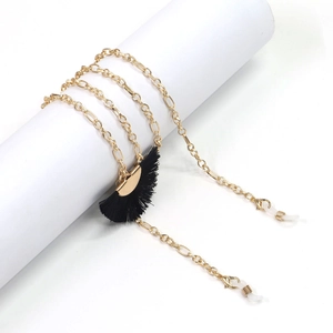 Detail of golden glasses chain featuring black fan fringe and adjustable rubber loops