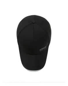 Top-down macro view of black cotton sports baseball cap showing six-panel crown structure